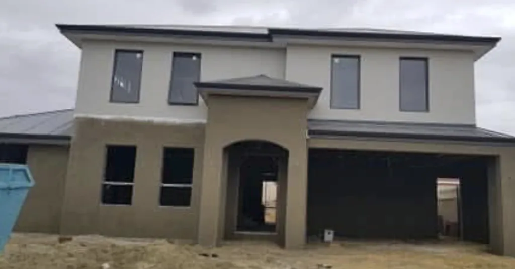 After: the same home with the lower storey rendered